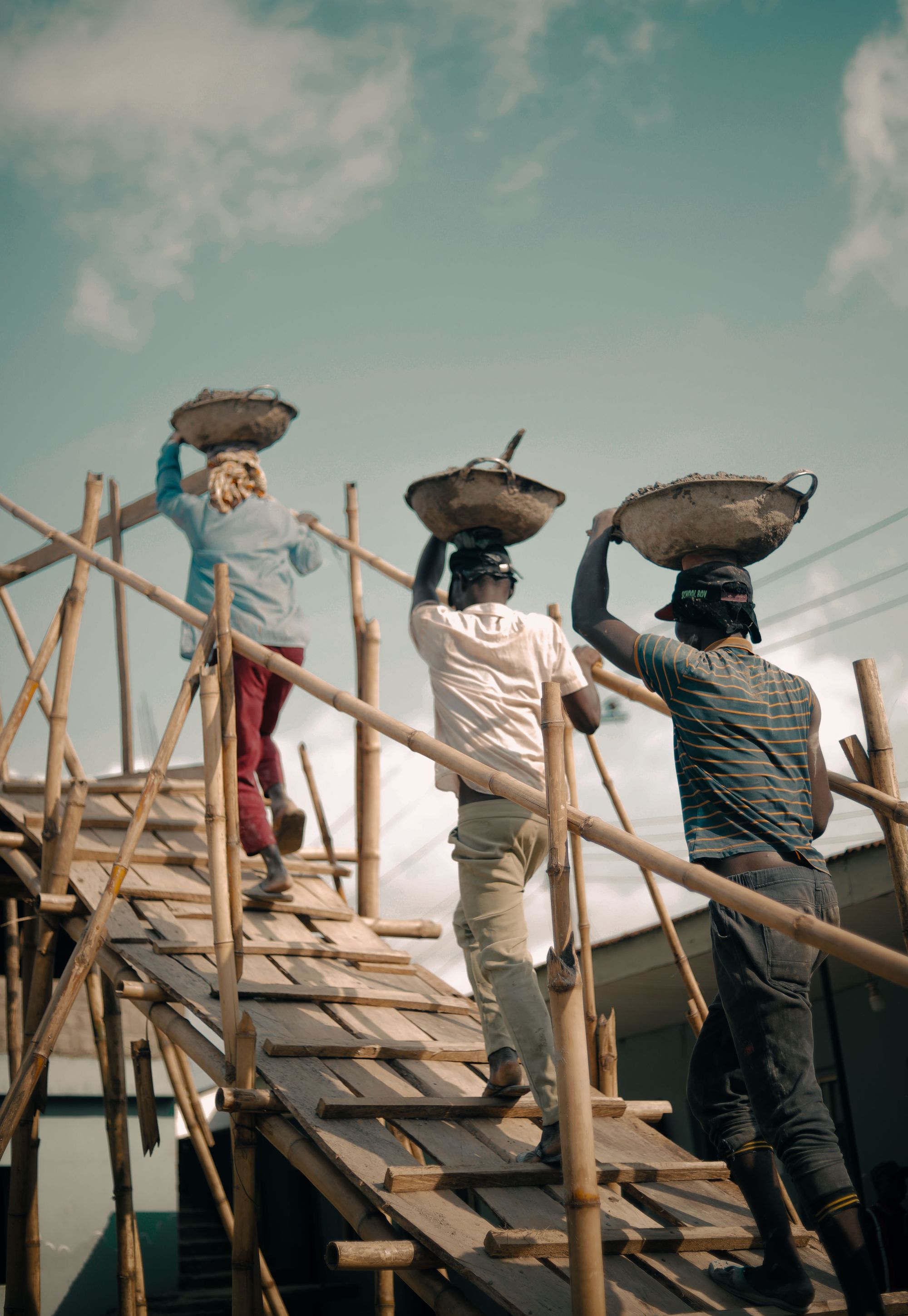 Workers carrying materials on a construction site in Nigeria